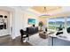 Bright living room with contemporary decor, a large TV, and sliding glass doors leading to an outdoor view at 2267 Mossy Vine Ave, St Cloud, FL 34771