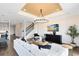 Open-concept living area with modern decor, chandelier and a staircase to the upper level at 2267 Mossy Vine Ave, St Cloud, FL 34771