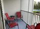Outdoor balcony with chairs overlooks the tennis court at 2305 Butterfly Palm Way # 304, Kissimmee, FL 34747