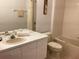 Well lit bathroom featuring a tub/shower, vanity with sink, toilet, and neutral accents at 2305 Butterfly Palm Way # 304, Kissimmee, FL 34747