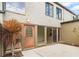 Charming back patio with a decorative door and sliding glass door entrance to the home's living area at 2500 21St Nw St # 58, Winter Haven, FL 33881