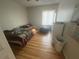Bedroom featuring hardwood floors, a comfortable bed, and natural light from the window at 2500 21St Nw St # 58, Winter Haven, FL 33881