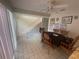 Dining area with tile flooring, a ceiling fan, and access to a staircase at 2500 21St Nw St # 58, Winter Haven, FL 33881