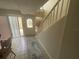 Bright entryway with tile floor, staircase, and glass paneled door at 2500 21St Nw St # 58, Winter Haven, FL 33881