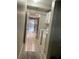 Hallway leading to the kitchen, featuring a laundry area with a washer and dryer for added convenience at 2500 21St Nw St # 58, Winter Haven, FL 33881