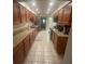 Spacious kitchen featuring tile flooring, granite countertops, and wooden cabinets at 2500 21St Nw St # 58, Winter Haven, FL 33881
