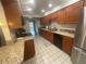 A kitchen featuring granite countertops, wood cabinets, and stainless steel appliances at 2500 21St Nw St # 58, Winter Haven, FL 33881