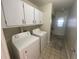 Dedicated laundry room with appliances, storage cabinets, and tile flooring at 2500 21St Nw St # 58, Winter Haven, FL 33881