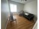 Comfortable living room with hardwood floors, a recliner, couch, and natural light from the window at 2500 21St Nw St # 58, Winter Haven, FL 33881