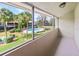 A screened-in patio offers a view of the community pool, palm trees and manicured green lawns at 2500 21St Nw St # 58, Winter Haven, FL 33881