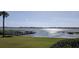 Scenic waterfront view, featuring a tranquil lake and a private dock extending into the shimmering water at 2500 21St Nw St # 58, Winter Haven, FL 33881