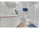 Clean bathroom with a walk-in shower, a large mirror, and coordinated blue towels and rug at 2821 Almaton Loop # 105, Kissimmee, FL 34747
