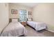 Cozy bedroom with twin beds, a shared nightstand, and natural light, ideal for children or guests at 2821 Almaton Loop # 105, Kissimmee, FL 34747