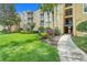 Exterior shot of condo building with lush landscaping and inviting walkway at 2821 Almaton Loop # 105, Kissimmee, FL 34747