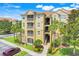 Beautiful condo building featuring balconies, lush landscaping and convenient parking at 2821 Almaton Loop # 105, Kissimmee, FL 34747