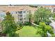 Beautiful condo building with lush landscaping and large green spaces at 2821 Almaton Loop # 105, Kissimmee, FL 34747