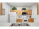 Bright kitchen with stainless steel sink and a full set of appliances surrounded by wooden cabinets at 2821 Almaton Loop # 105, Kissimmee, FL 34747