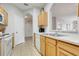 An open concept kitchen with a double sink, dishwasher, and view into the dining room at 2821 Almaton Loop # 105, Kissimmee, FL 34747