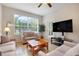 Bright living room featuring tile floors, large window and comfortable furnishings at 2821 Almaton Loop # 105, Kissimmee, FL 34747