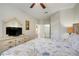 Comfortable bedroom with ceiling fan and TV, leading to ensuite bathroom and closet area at 2821 Almaton Loop # 105, Kissimmee, FL 34747