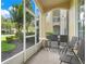 Comfortable screened-in patio with seating and a view of the well-maintained landscaping at 2821 Almaton Loop # 105, Kissimmee, FL 34747