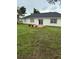 Features an expansive, well-maintained backyard with lush grass and garden area with an outdoor patio at 2864 Trenton Ln, Deltona, FL 32738