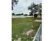 A sprawling backyard includes green grass, a garden area and a storage shed, all enclosed by a white fence at 2864 Trenton Ln, Deltona, FL 32738