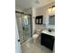 Nicely updated bathroom featuring a shower with black hardware, and modern vanity and mirror at 2864 Trenton Ln, Deltona, FL 32738