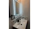 Modern bathroom vanity features a sleek countertop and illuminated mirror with decorative tile backsplash at 2864 Trenton Ln, Deltona, FL 32738