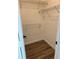 Walk-in closet featuring built-in shelving and laminate flooring at 2864 Trenton Ln, Deltona, FL 32738