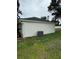 Exterior view of the house with a well-maintained lawn and newly painted stucco siding at 2864 Trenton Ln, Deltona, FL 32738