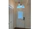 Welcoming front door with decorative transom window and sidelight, accented by stylish pendant lights at 2864 Trenton Ln, Deltona, FL 32738