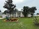 Charming single-story home featuring a well-manicured lawn and tasteful landscaping with colorful flowerbeds at 2864 Trenton Ln, Deltona, FL 32738