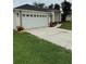 Spacious two-car garage with a concrete driveway, offering ample parking and convenient access to the home at 2864 Trenton Ln, Deltona, FL 32738