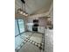 Bright kitchen with stainless steel appliances, sleek cabinets, and sliding glass door to the backyard at 2864 Trenton Ln, Deltona, FL 32738