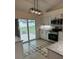 Bright kitchen with stainless steel appliances and a sliding glass door to backyard at 2864 Trenton Ln, Deltona, FL 32738