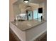 The kitchen has granite countertops, stainless steel appliances, and natural light from the sliding glass doors at 2864 Trenton Ln, Deltona, FL 32738