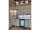 Modern kitchen with white cabinets, granite countertops, and stainless steel appliances at 2864 Trenton Ln, Deltona, FL 32738