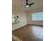 The open living area boasts tile flooring, a ceiling fan, and natural light from the large window at 2864 Trenton Ln, Deltona, FL 32738