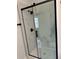 Contemporary bathroom shower with black hardware, glass enclosure, and marble-patterned tile surround at 2864 Trenton Ln, Deltona, FL 32738