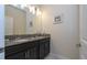 Bathroom with double sinks, granite counters, and modern fixtures at 3085 Tom Sawyer Dr, Kissimmee, FL 34746