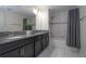 Bathroom with double sinks, dark cabinets, granite countertops and a tiled tub and shower combo at 3085 Tom Sawyer Dr, Kissimmee, FL 34746