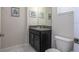 This bathroom boasts a granite vanity, toilet, and ample lighting for a functional space at 3085 Tom Sawyer Dr, Kissimmee, FL 34746