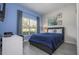 Comfortable bedroom with natural light, modern decor, and cool-toned walls at 3085 Tom Sawyer Dr, Kissimmee, FL 34746