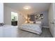 Well-lit bedroom with calming gray tones, soft bedding, and a view into the en-suite bathroom at 3085 Tom Sawyer Dr, Kissimmee, FL 34746