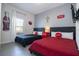 Fun bedroom with two beds, Coca-Cola decor and bright red accents at 3085 Tom Sawyer Dr, Kissimmee, FL 34746