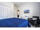 Comfortable bedroom with a large closet, TV, chair and blue bedding at 3085 Tom Sawyer Dr, Kissimmee, FL 34746