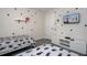 Stylized bedroom features two twin beds, Mickey accents, and a flat screen TV on the wall at 3085 Tom Sawyer Dr, Kissimmee, FL 34746