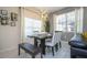 Cozy dining area showcasing modern chandelier lighting, a dining table with bench, and window views at 3085 Tom Sawyer Dr, Kissimmee, FL 34746