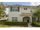 Charming two-story home featuring neat landscaping, tiled roof and covered entry way at 3085 Tom Sawyer Dr, Kissimmee, FL 34746